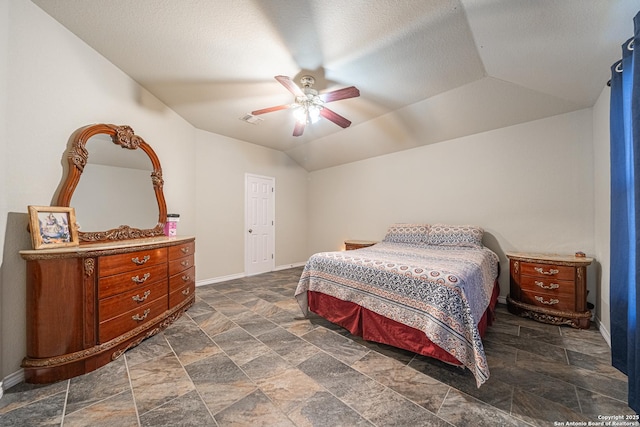 bedroom featuring lofted ceiling, a textured ceiling, and ceiling fan