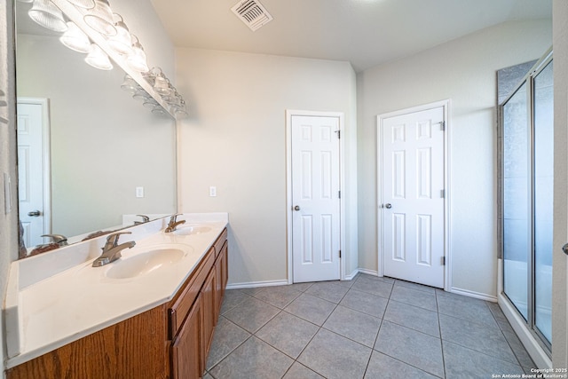 bathroom featuring vanity, a shower with shower door, and tile patterned flooring