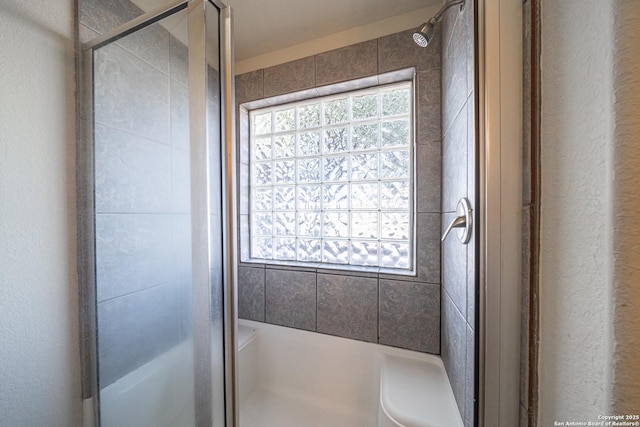 bathroom with a shower with door