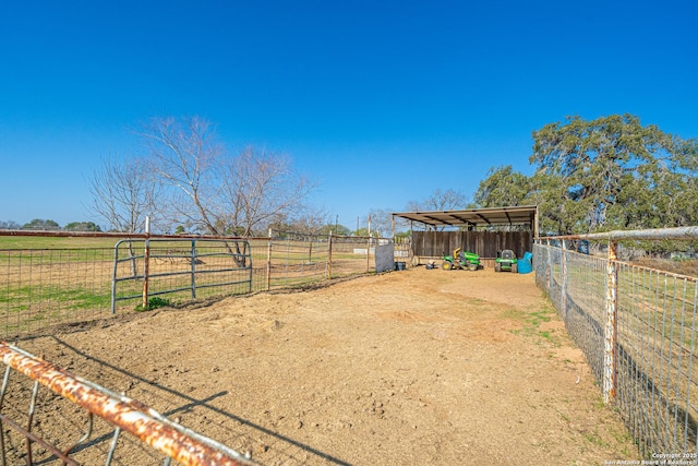 view of yard with a rural view and an outbuilding