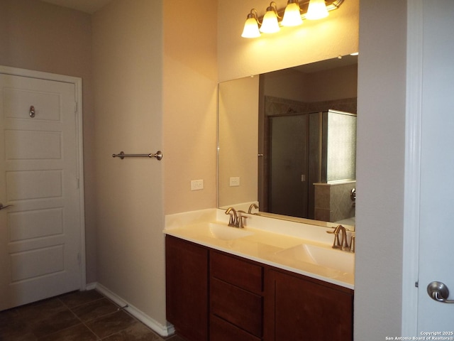 bathroom featuring a shower with door, vanity, and tile patterned floors