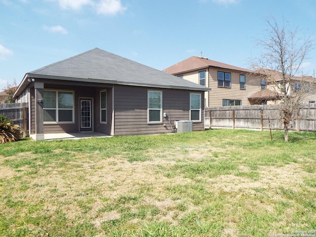 rear view of house featuring a patio area and a lawn