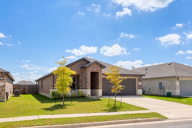 view of front of property featuring central AC, a garage, and a front yard