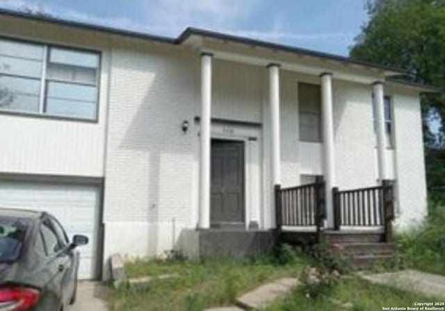 view of front facade featuring a porch and a garage