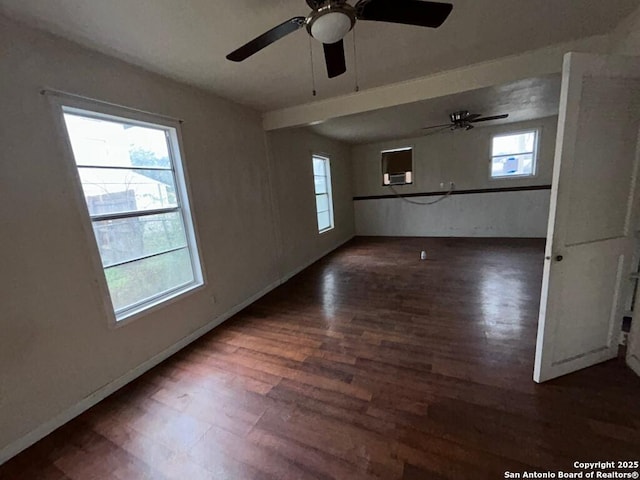 unfurnished room featuring plenty of natural light and dark wood-type flooring