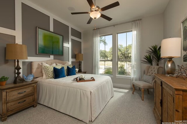 bedroom featuring ceiling fan and light carpet