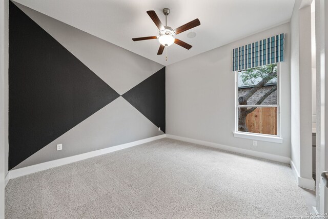 empty room featuring ceiling fan and light colored carpet