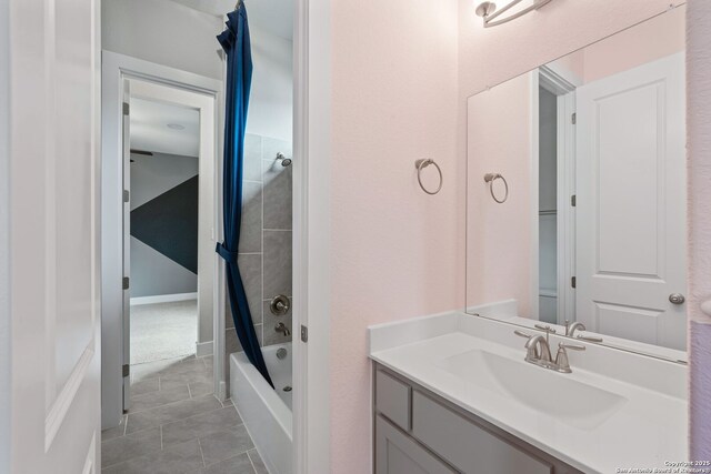 bathroom with tile patterned floors, vanity, and shower / bath combo with shower curtain