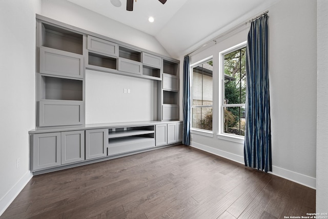 unfurnished living room with lofted ceiling, dark hardwood / wood-style floors, and ceiling fan