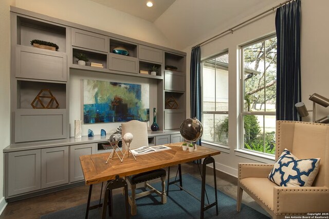 home office featuring lofted ceiling and dark hardwood / wood-style floors