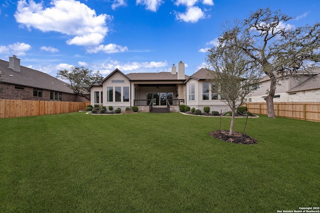 back of house featuring a lawn