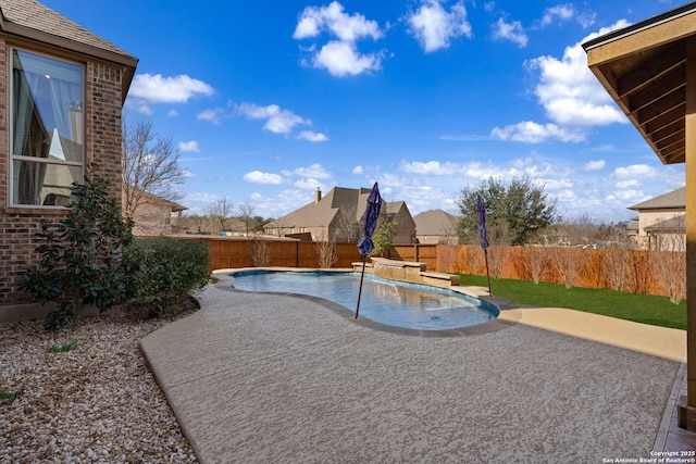 view of pool with a fenced in pool, a fenced backyard, and a patio