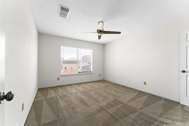 unfurnished room with ceiling fan, a textured ceiling, and carpet flooring