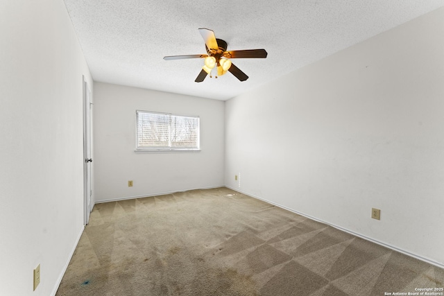 carpeted empty room featuring ceiling fan and a textured ceiling