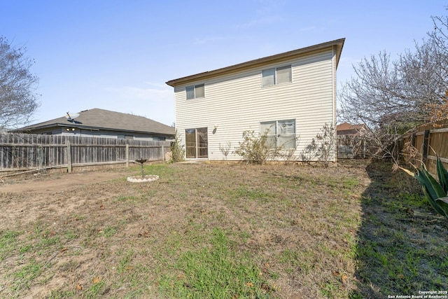 rear view of house featuring a lawn