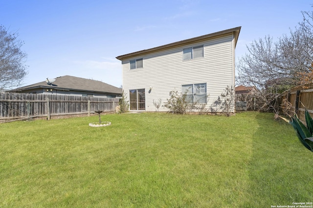 back of house with a lawn