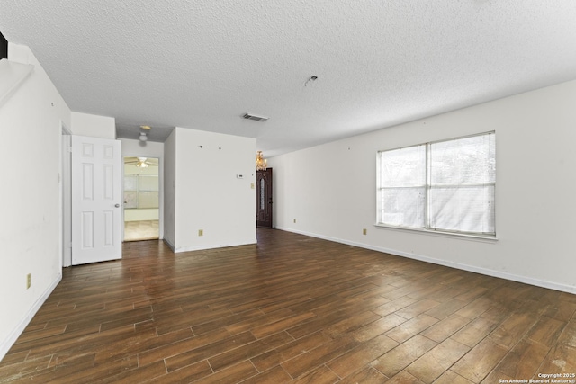 unfurnished living room with ceiling fan, dark hardwood / wood-style flooring, and a textured ceiling