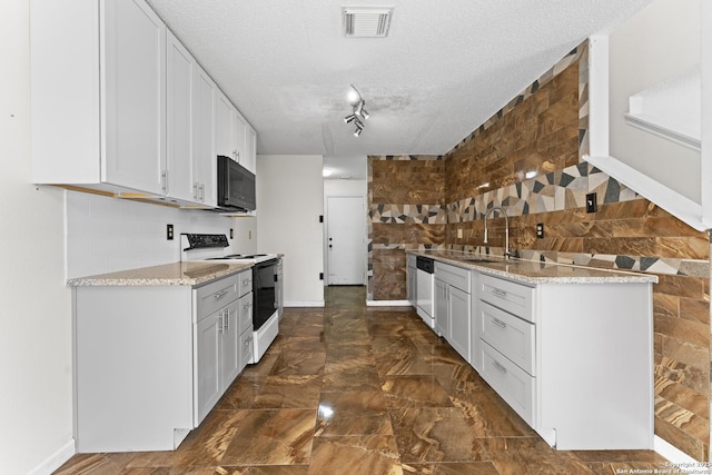 kitchen with white cabinetry, sink, stainless steel dishwasher, and electric stove