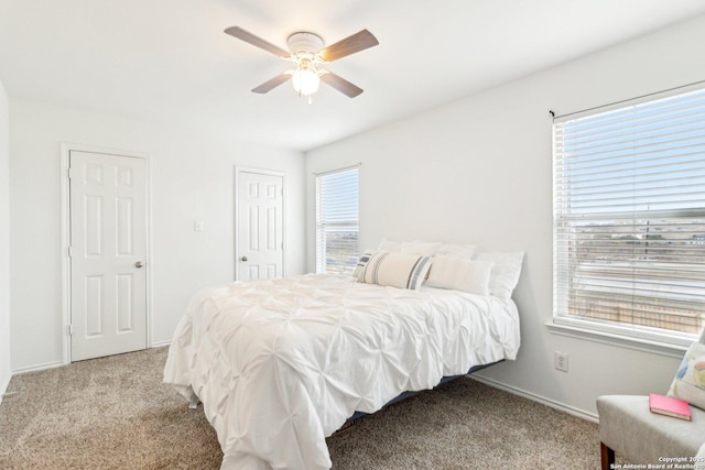 bedroom featuring carpet floors, multiple windows, and ceiling fan