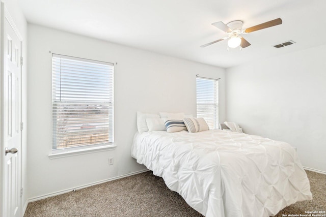 bedroom with ceiling fan, carpet floors, and visible vents