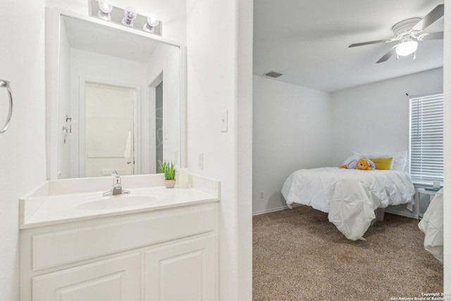 bedroom featuring carpet flooring, a sink, visible vents, and ceiling fan