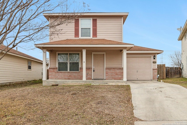 traditional home with concrete driveway, brick siding, an attached garage, and fence