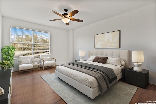 bedroom with ceiling fan and dark hardwood / wood-style flooring