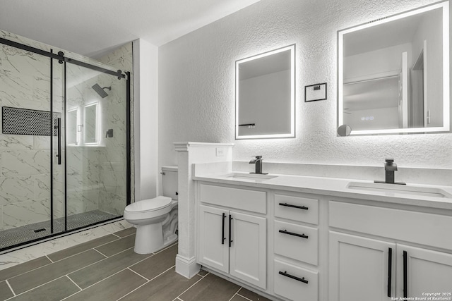 bathroom with vanity, toilet, and an enclosed shower