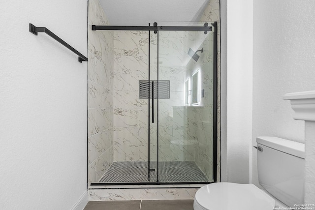 bathroom featuring walk in shower and toilet