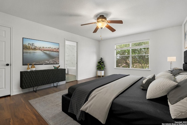 bedroom featuring dark hardwood / wood-style flooring, a textured ceiling, ceiling fan, and ensuite bathroom