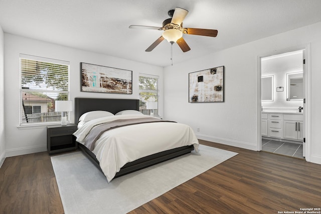 bedroom featuring ensuite bathroom, ceiling fan, and dark hardwood / wood-style flooring