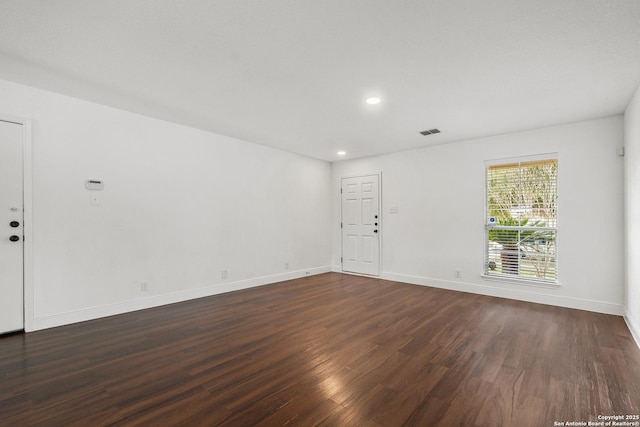 spare room featuring dark hardwood / wood-style floors