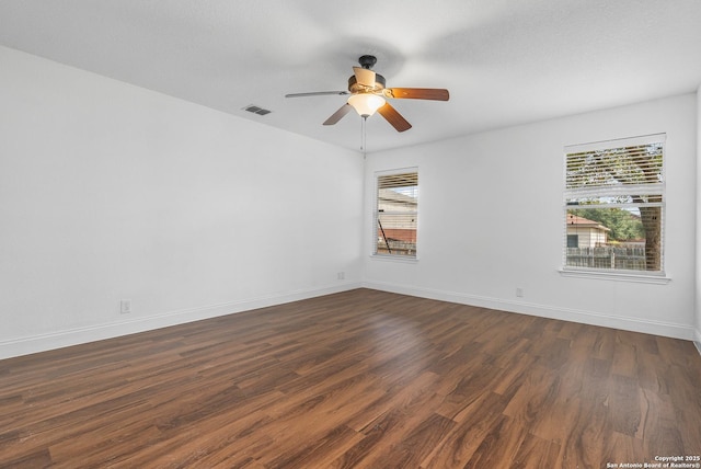 unfurnished room featuring dark wood-type flooring and ceiling fan