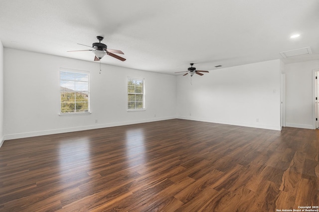 spare room with dark wood-type flooring and ceiling fan