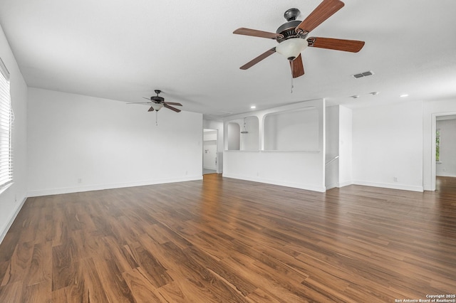 unfurnished living room with dark wood-type flooring and ceiling fan