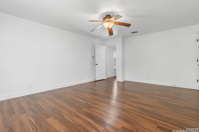 spare room with dark hardwood / wood-style floors and ceiling fan