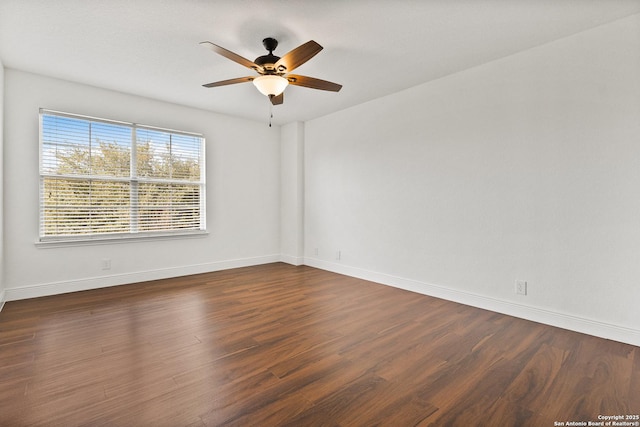 unfurnished room with ceiling fan and dark hardwood / wood-style flooring