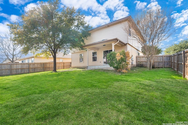 rear view of house with a lawn