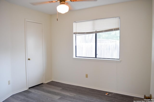 unfurnished bedroom with dark hardwood / wood-style floors and ceiling fan