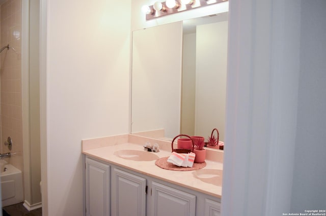 bathroom featuring vanity and shower / tub combination