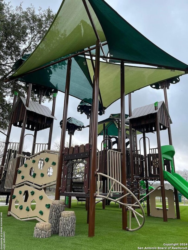 view of playground with a lawn