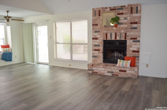 living room featuring ceiling fan, lofted ceiling, dark wood-type flooring, and a fireplace