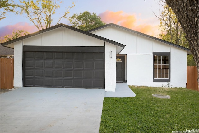 view of front facade with a garage and a lawn