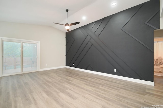 spare room featuring vaulted ceiling, ceiling fan, and light hardwood / wood-style floors