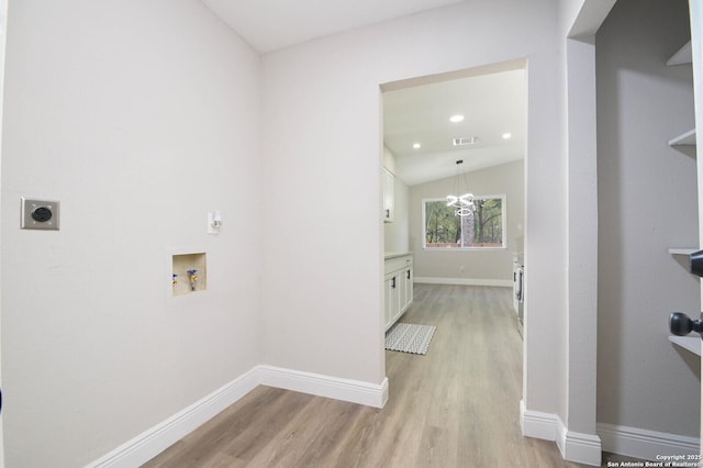 washroom with electric dryer hookup, washer hookup, and light hardwood / wood-style flooring