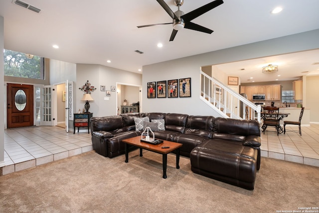 carpeted living room with ceiling fan