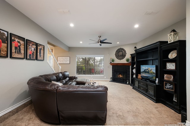 living room with ceiling fan and carpet