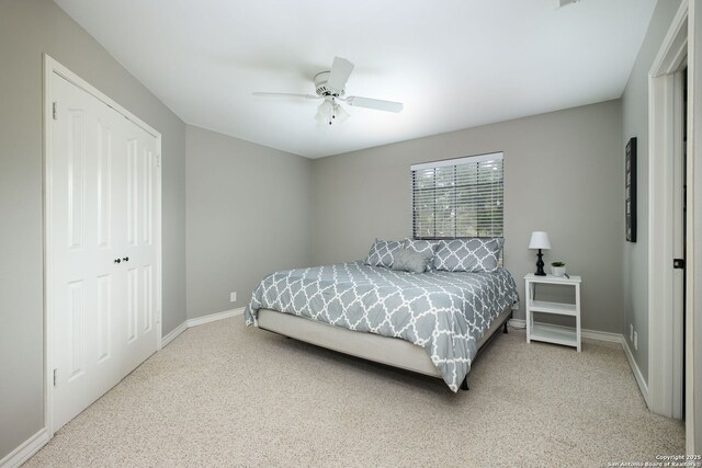 carpeted bedroom with a closet and ceiling fan