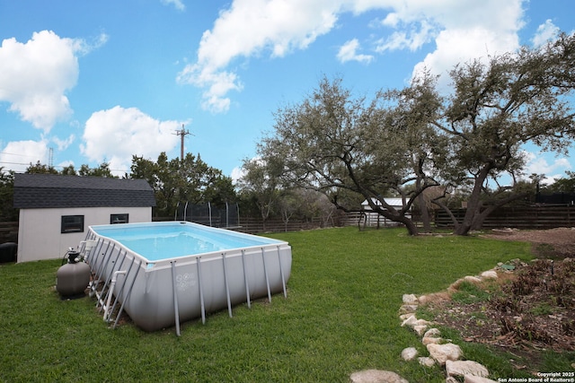 view of pool featuring a shed and a lawn