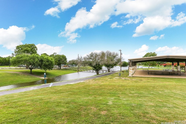 view of community featuring a water view and a lawn